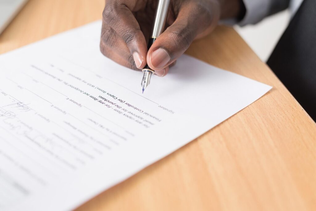 A person signing a contract with an international moving company