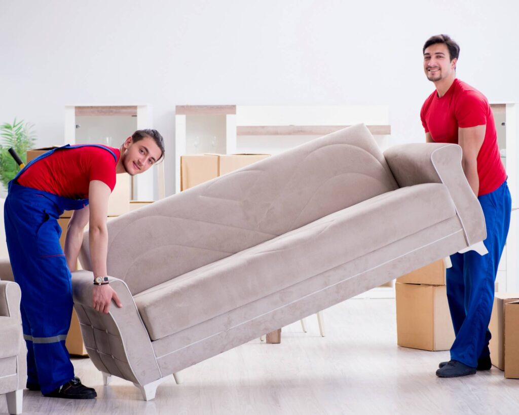 Professional international movers lifting a couch