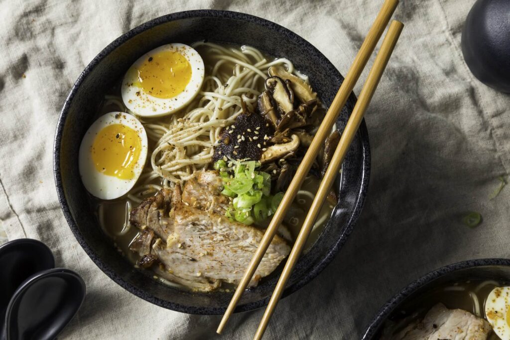 A bowl of Japanese ramen with chopsticks laid on the plate