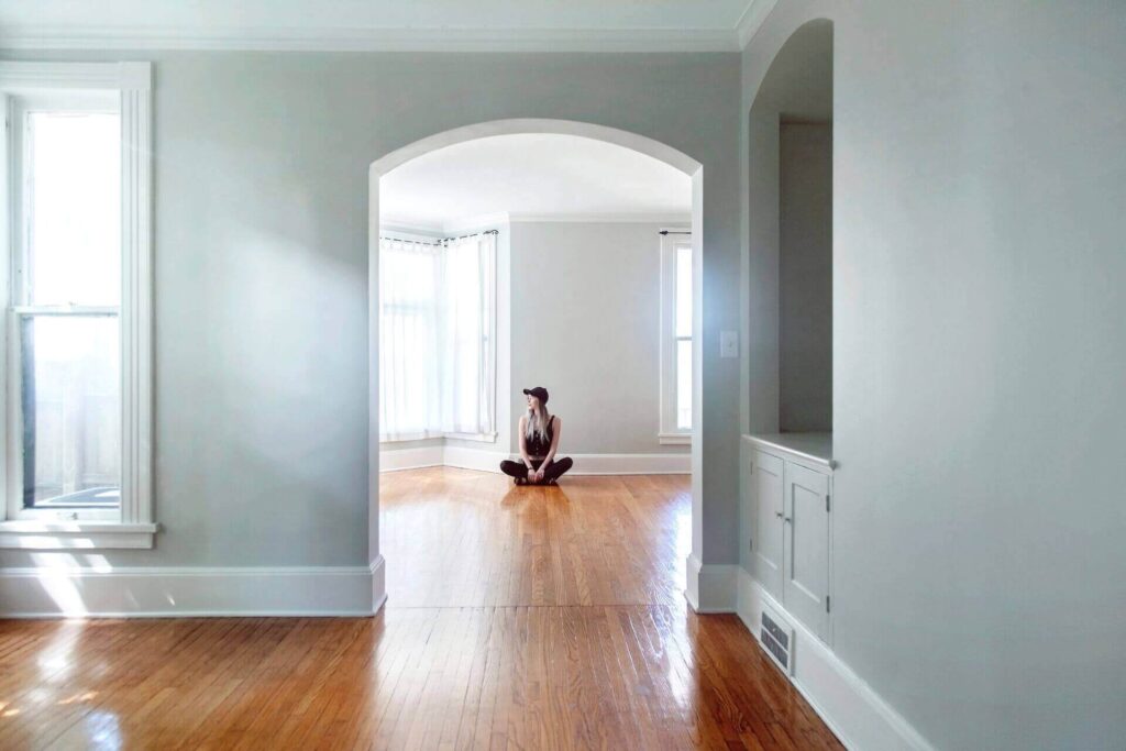 Girl sitting in an empty apartment after moving abroad