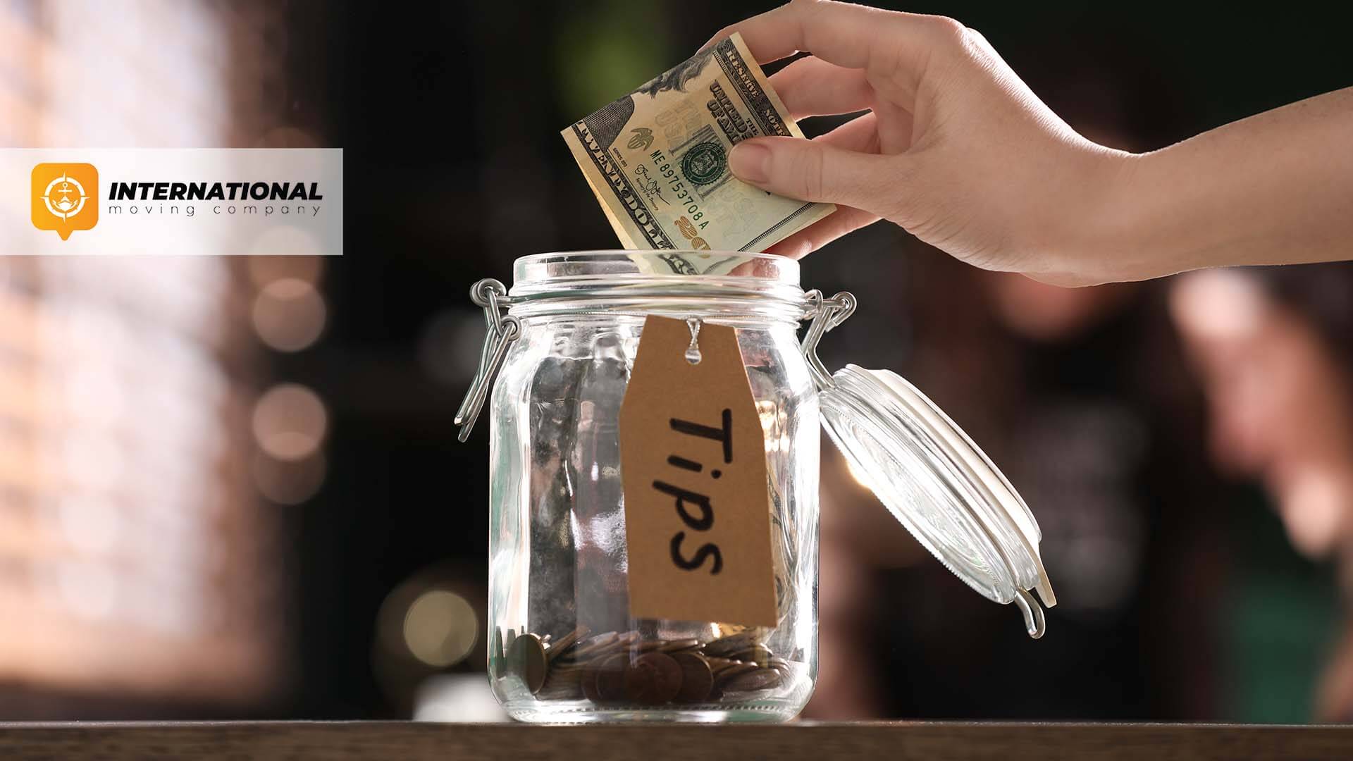 Person putting money in a jar labeled "tips"