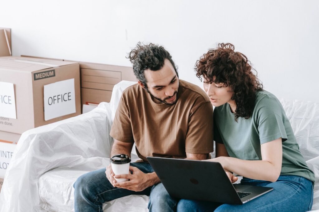 A woman and a man looking for an international moving company online