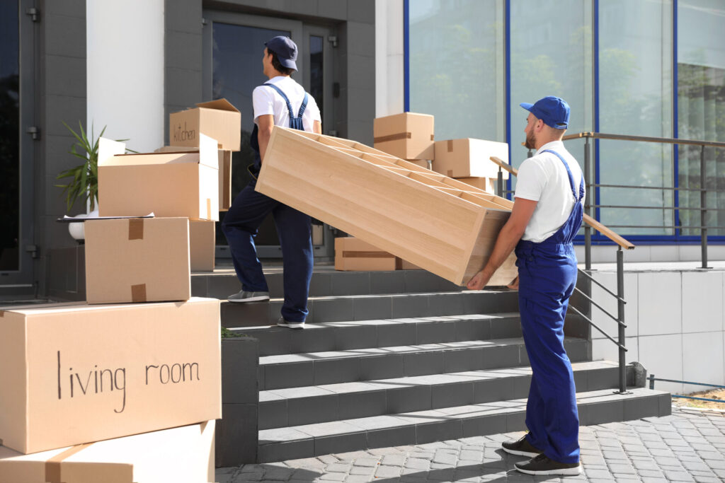 International movers carrying a shelf into the house